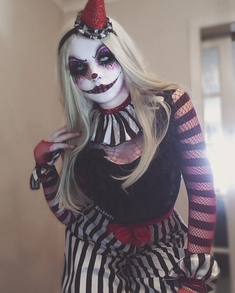 Woman with blonde wig in Halloween clown makeup