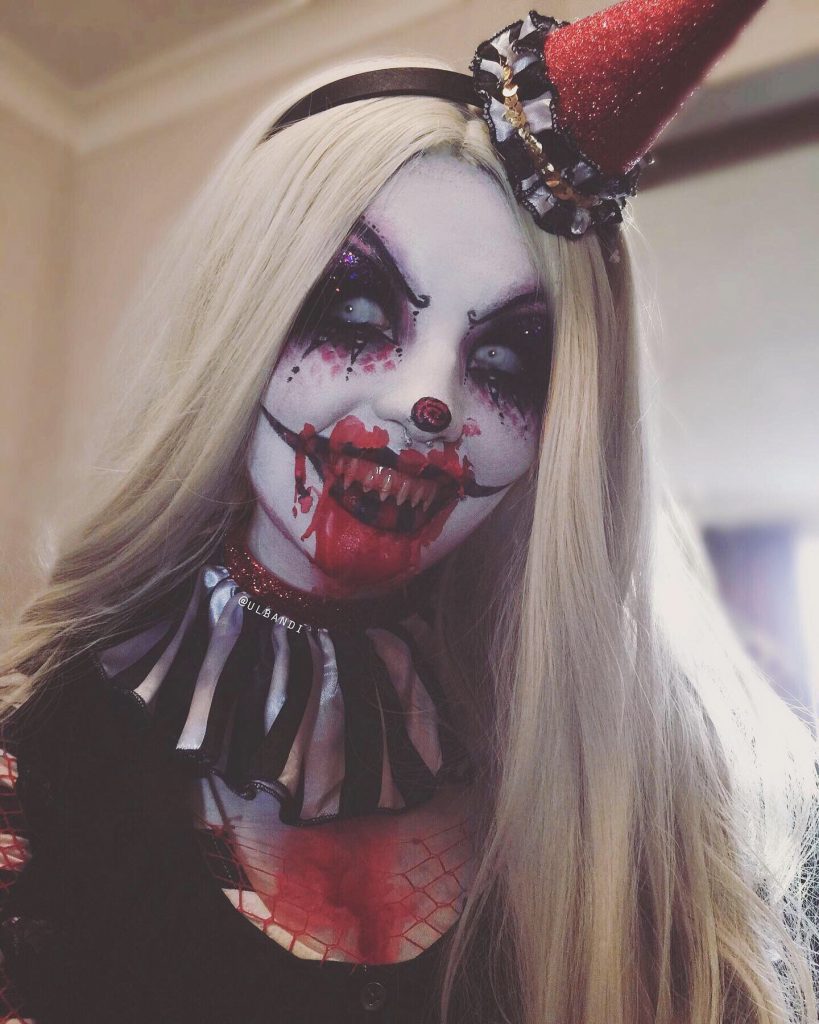 Woman with blonde wig in Halloween clown makeup